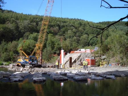 Pile driving in the river bed for support foundations to the new aqueduct Pile driving in the river bed for support foundations to the new aqueduct